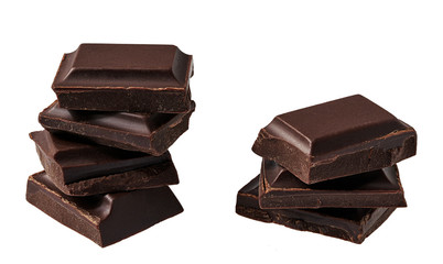 Cubes of dark chocolate tower isolated on a white background.