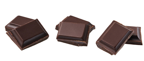 Dark chocolate pieces isolated on white background.
