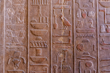 Egyptian ancient hieroglyphs on the stone wall in a temple of Hatshepsut