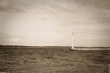 Lighthouse or old beacon under storm clouds