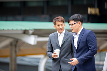 Two businessmen talking at outdoor against building