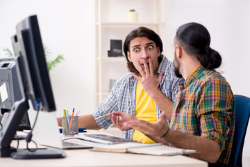 Two it specialists working in the office