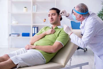 Male patient visiting doctor otolaryngologist