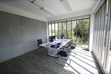 Desks with PCs in bright and modern open space office