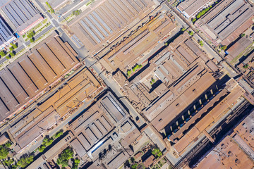weathered metal roofs of old factory buildings. urban industrial district, aerial top view