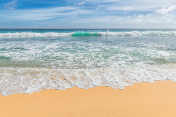 Beautiful ocean sandy beach with soft blue wave and golden sand.