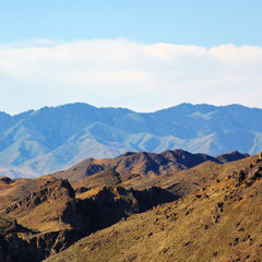 Fototapeta premium Rainbow over the big Charyn canyon. Kazakhstan. Mountains. travel, nature, dark sky. sunny. square format.