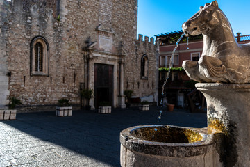 Duomo Square in Taormina, Sicily - Detail of Four Fountains with a stream of water, Cathedral in the background