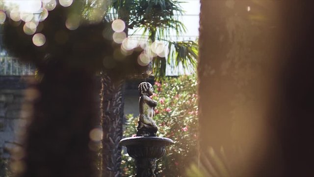Old fountain with a small statue in a garden