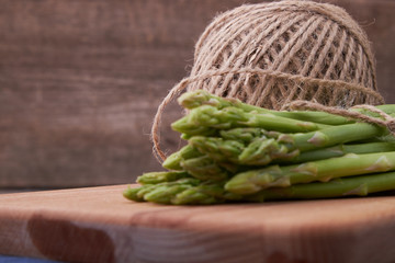 Seasonal product fresh green Asparagus on dark background
