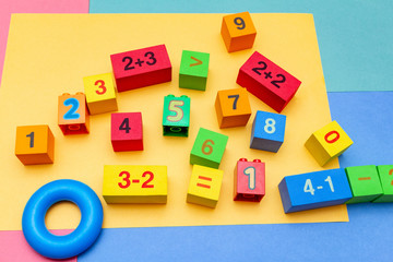 child kid colorful education toys cubes with numbers math pattern background on the bright background. Flat lay. Childhood infancy children babies concept.