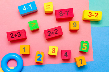 child kid colorful education toys cubes with numbers math pattern background on the bright background. Flat lay. Childhood infancy children babies concept.
