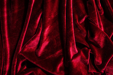 Background image of crumpled fabric. Red velvet