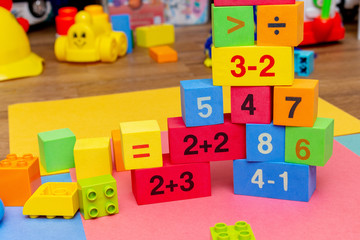 Fototapeta na wymiar child kid colorful education toys cubes with numbers math pattern background on the bright background. Flat lay. Childhood infancy children babies concept.
