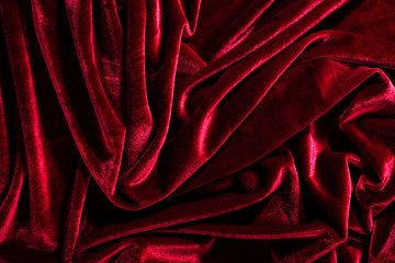 Background image of crumpled fabric. Red velvet