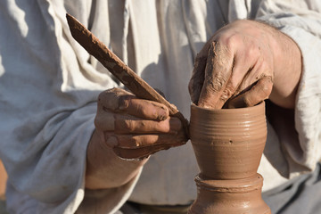 Pottery male ceramist creates a hand made clay product