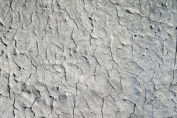 many cracks in the texture of the old gray bitumen