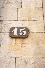 Number Fifteen on Stone Wall