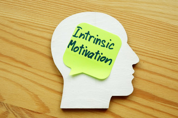 Intrinsic motivation written on a wooden head silhouette.