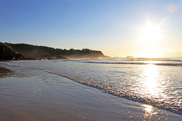 Walking north in the early morning light at Aanuka beach. Australia.