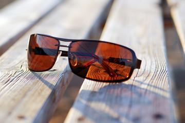 brown sunglasses on a wooden table