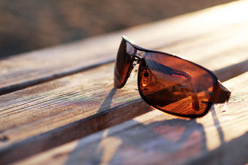 brown sunglasses on a wooden table