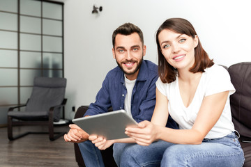 Positive couple using wifi at home