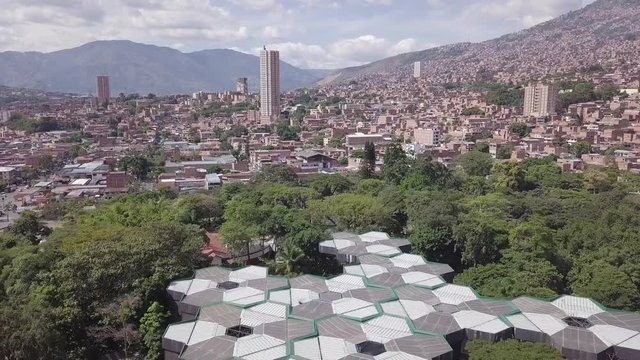Beautiful revealing slow 4k aerial shot of Botanical Garden and Medellin city downtown
