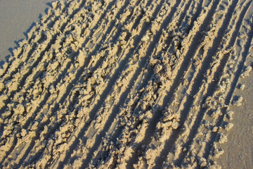 Traces of scratches in the sand sunrise background sea, texture