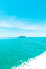 Fototapeta premium Looking at the Island, blue water and sky.