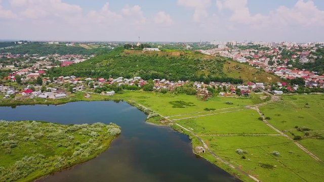 Aerial view of blue river whit reflections on a sunny summer day. Drone flight over the River Olt, Romania.