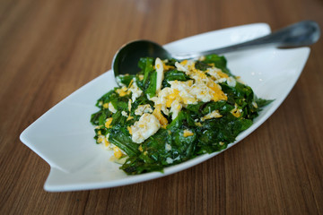 Stir-fried Baegu leaves with egg or Gnetum gnemon or Malindjo, Thai Southern traditional food style.