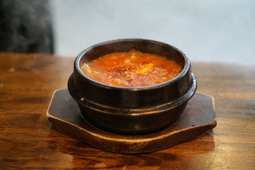 Kimchi Tofu Soup served in clay pot, One of the most-loved of all the stews in Korean cuisine, Most popular food in Korea.