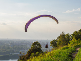 Paraglider flying over the big city.