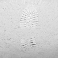 Footprint from a boot on a gray stone background. Moon surface texture. First step. Flat lay, top view