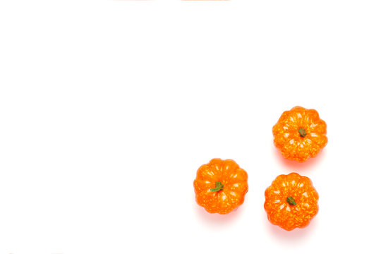 Decorative pumpkins on a white background. Halloween concept, harvest, autumn. Flat lay, top view