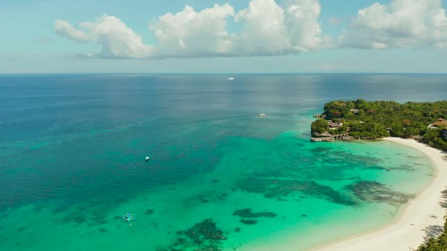 Tropical white sand beach, hotels near the blue lagoon and corall reef. aerial view, Boracay, Philippines. Seascape with beach on tropical island. Summer and travel vacation concept.
