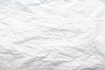 Crumpled white paper. Texture. Can be used as background or wallpaper. Flat lay, top view