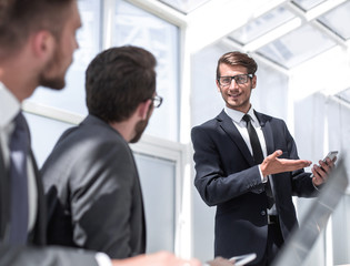close up.businessman showing on the screen of his smartphone