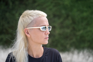 Portrait of a blonde girl on a background of nature.