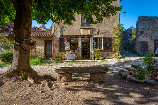 Old fashioned store with weathered stone bench, Perouges, France