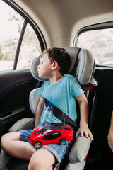 
sleeping boy in the car seat