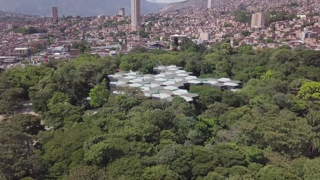 Stunning aerial revealing shot of Jadin Botanico and Medellin city centre