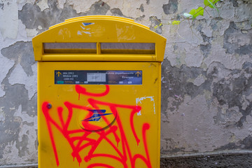 Orange graffitis on a french mailing box