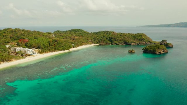 Tropical sandy beach near the blue lagoon and corall reef, aerial view Boracay, Philippines. Ilig Iligan Beach. Summer and travel vacation concept.