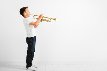 a child playing trumpet on white background