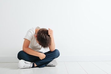 a child whose depression is sitting on the floor