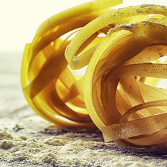 Pasta uncooked on the table. Noodles in the form of nests.