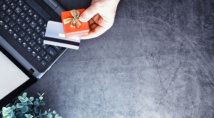 Obraz premium Shopping concept. Supermarket trolley and gifts on the background.