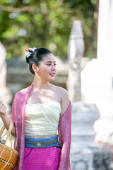 ortrait of an Asian Women in Thai Lanna and Shan Traditional Clothes are Standing Against Thailand Temple